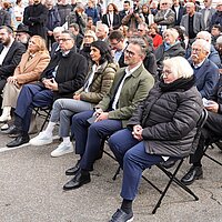 Viele Personen auf Stühlen 