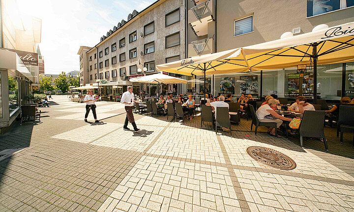 Ansicht: Restaurant in Fußgängerzone mit Kellner 