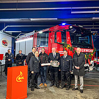 Auf dem Bild stehen obin Fix, stellvertretender Abteilungskommandant Abteilung Eutingen, Feuerwehrkommandant Sebastian Fischer, Andreas Reichenbach, Firma Magirus, Jürgen Karst, Abteilungskommandant Abteilung Eutingen sowie Carsten Löwes, stellvertretender Abteilungskommandant Abteilung Eutingen und Erster Bürgermeister Dirk Büscher vor dem neuen Feuerwehrauto.